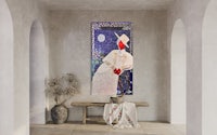 a painting of a woman with a hat hanging on a wall